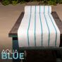 The aqua blue towel on a table at the beach. 