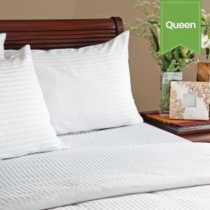 A bed with two pillows using Swiss Stripes.